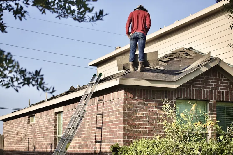 Professional roofer working on a residential roof in Pleasantville